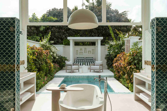 Sun Siyam Iru Veli, Dhaalu Atoll — open-air bathroom pavilion with teal fish-scale columns and a freestanding tub beside the pool