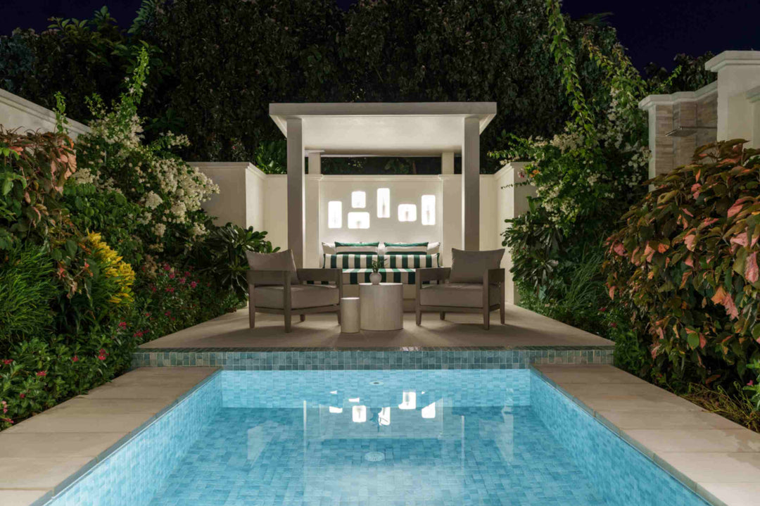Sun Siyam Iru Veli, Dhaalu Atoll — walled pool court at night with the bathroom pavilion lit behind it