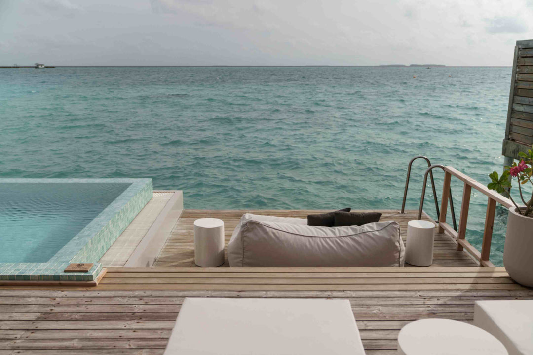 Sun Siyam Iru Veli, Dhaalu Atoll — overwater deck with the pool at the lagoon edge and a ladder into the sea