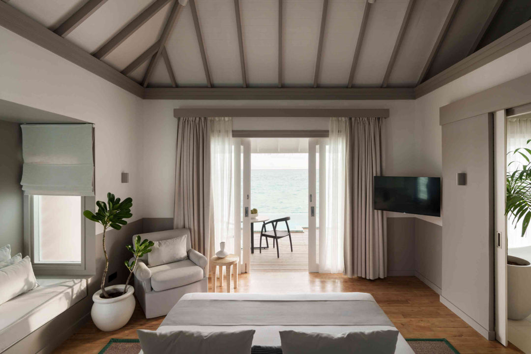 Sun Siyam Iru Veli, Dhaalu Atoll — bedroom looking out through open doors to the deck and the sea