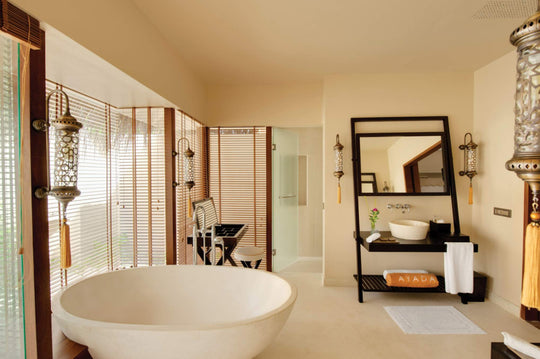 A lagoon suite bathroom at Ayada Maldives, freestanding tub and a long twin vanity