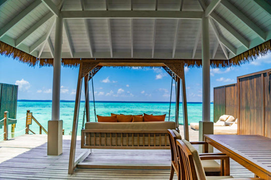 A shaded daybed pavilion over the water at Ayada Maldives looking across the lagoon