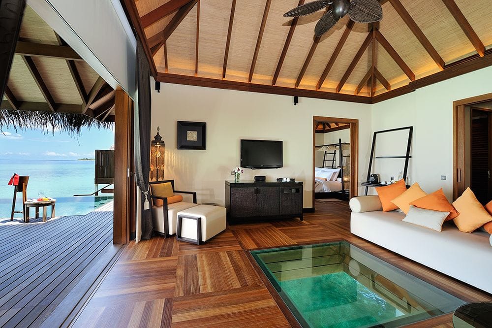 A sunset ocean suite at Ayada Maldives, bed and sitting area beside the private plunge pool