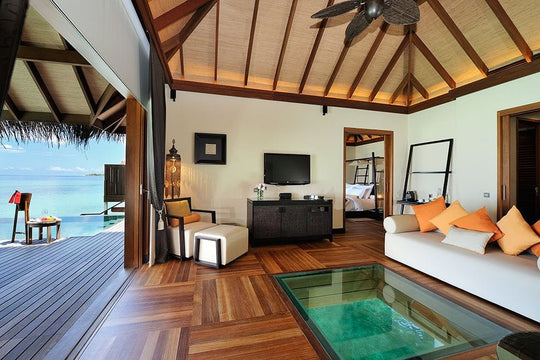A sunset ocean suite at Ayada Maldives, bed and sitting area beside the private plunge pool