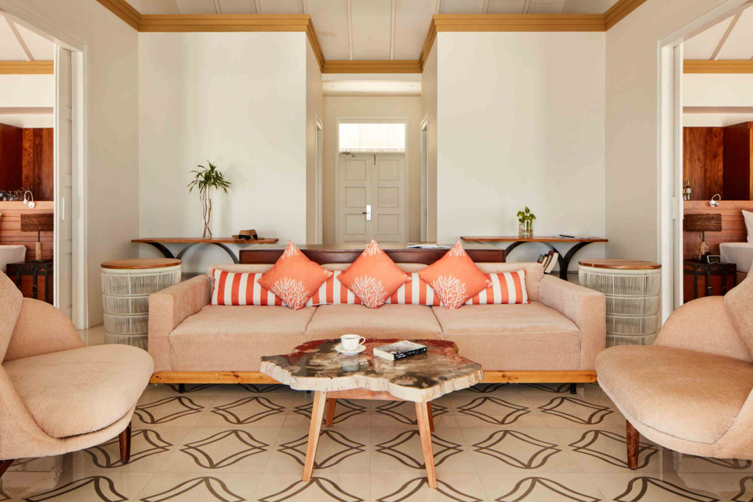Sun Siyam Iru Veli, Dhaalu Atoll — living room with a long sofa on a patterned rug, twin vanities either side