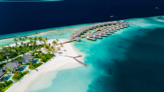 ananea Madivaru Maldives from the air, the overwater villas reaching out from the beach into the lagoon