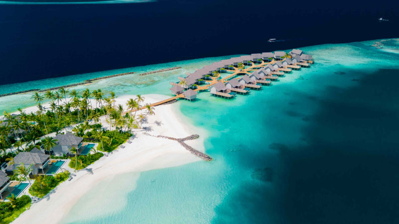 ananea Madivaru Maldives from the air, the overwater villas reaching out from the beach into the lagoon