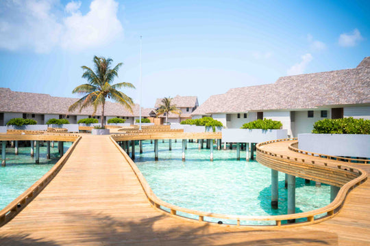 The timber jetty running out between the overwater villas at ananea Madivaru Maldives