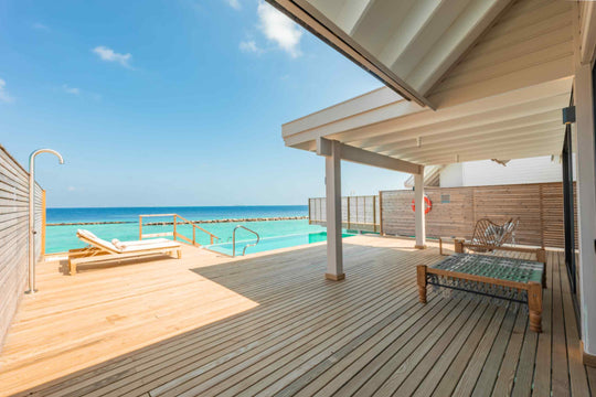 Water Pool Villa, Lagoon View at ananea Madivaru Maldives, sun loungers on the deck looking out over the lagoon
