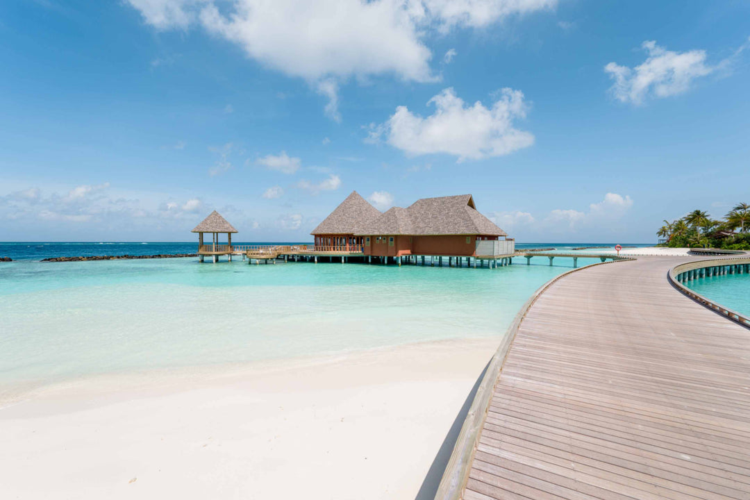 The overwater restaurant at ananea Madivaru Maldives seen from the timber jetty crossing the lagoon