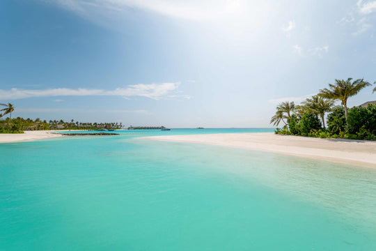 A quiet stretch of beach at ananea Madivaru Maldives, pale sand meeting still water