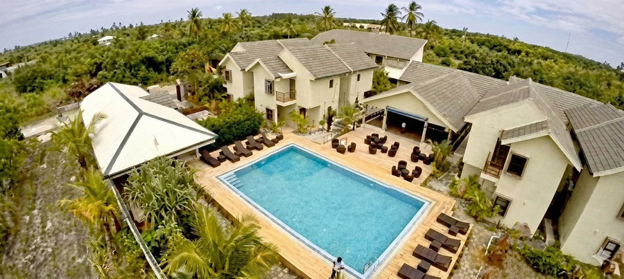 Long Beach Laamu, Gan, Laamu Atoll: aerial view of the two-storey guest house buildings around the swimming pool, with sun loungers and palms
