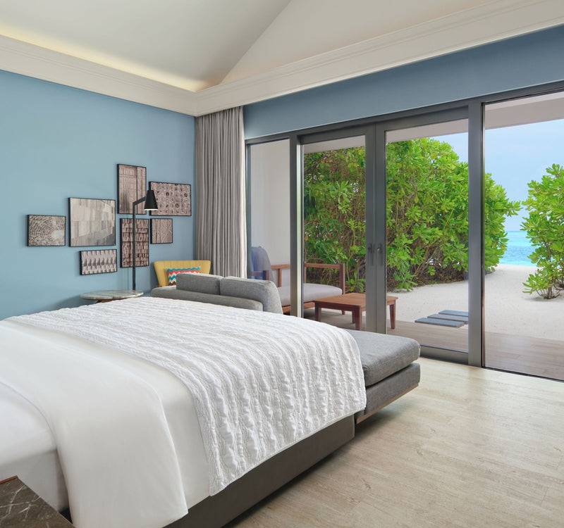 The bedroom of a Beach Villa with Garden Pool at Le Méridien Maldives Resort & Spa