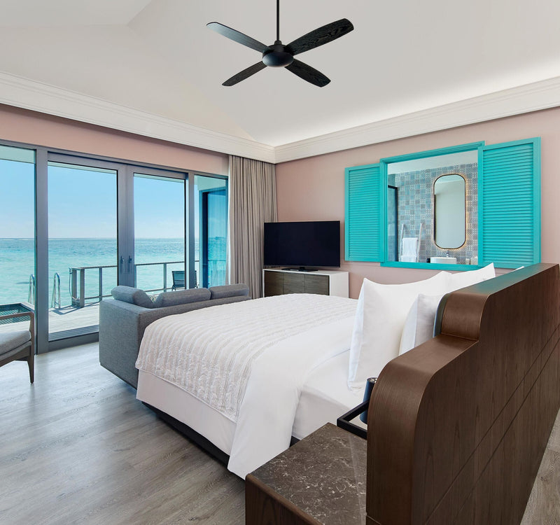 The bedroom of a Sunset Overwater Villa at Le Méridien Maldives Resort & Spa