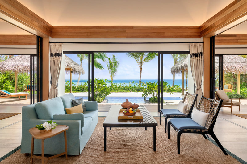 The living room of a Two-Bedroom Beach Pool Villa at Hilton Maldives Amingiri Resort & Spa.