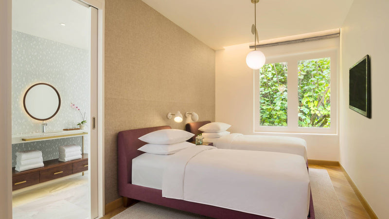 The twin bedroom of a Duplex Beach Pool Villa at JW Marriott Maldives Resort & Spa