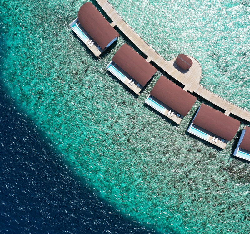 The overwater villas at The Westin Maldives Miriandhoo Resort seen from the air