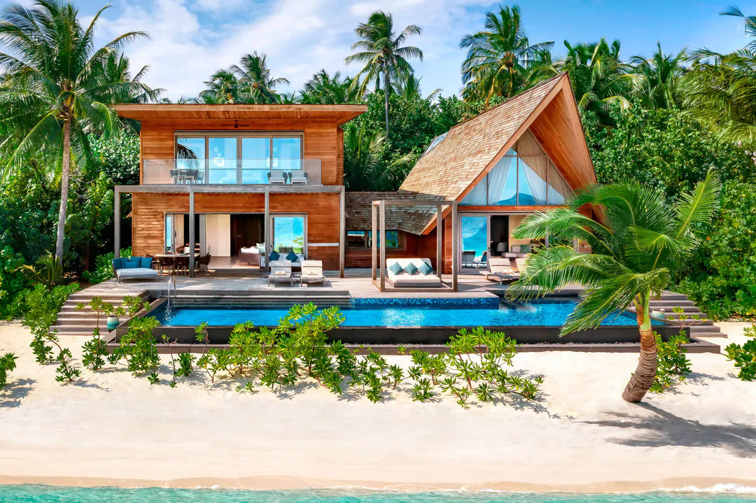 The St. Regis Maldives Vommuli, Dhaalu Atoll — Two-storey beach villa on the sand with a long pool and a thatched shade pavilion