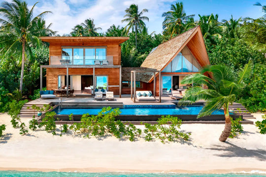 The St. Regis Maldives Vommuli, Dhaalu Atoll — Two-storey beach villa on the sand with a long pool and a thatched shade pavilion