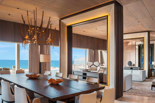 The St. Regis Maldives Vommuli, Dhaalu Atoll — Dining room with a long table, a sculptural chandelier and full-height glass onto the sea