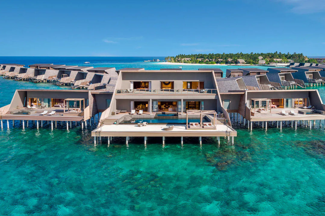 The St. Regis Maldives Vommuli, Dhaalu Atoll — Aerial view of a large overwater residence, several pavilions and decks above the lagoon
