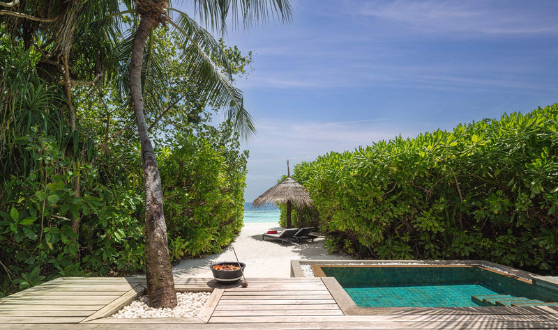 NH Collection Maldives Havodda Resort, Gaafu Dhaalu Atoll: the terrace of a Sunrise Beach Pool Villa, with a private plunge pool and a path through the greenery to the beach.
