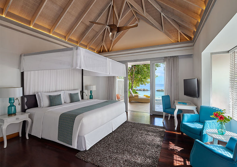 The bedroom of a One Bedroom Beach Pool Villa at NH Maldives Kuda Rah Resort.