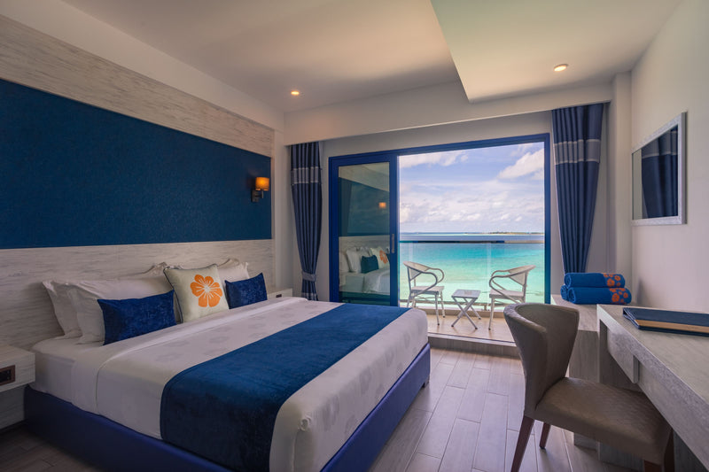 Deluxe double sea-view room at Kaani Palm Beach with a balcony onto the water