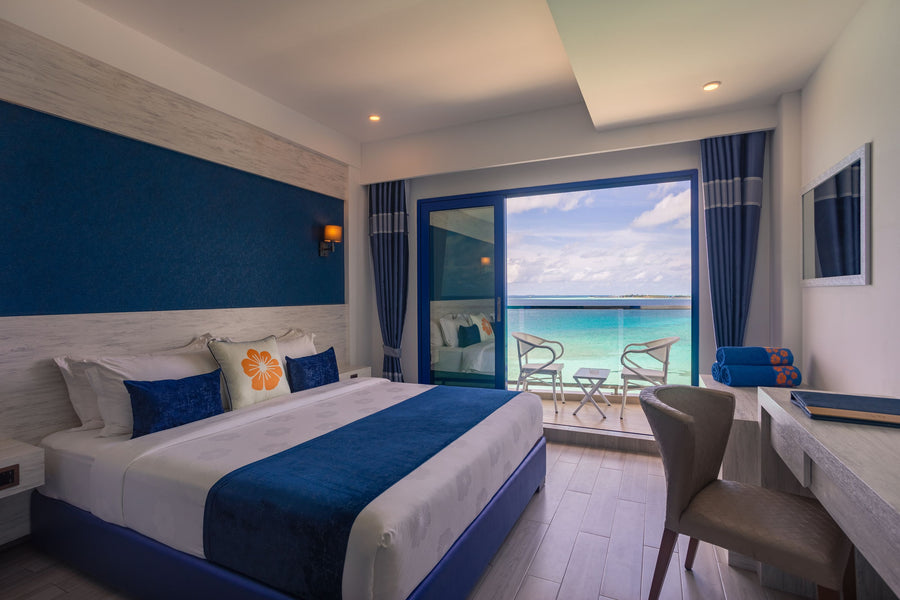 Deluxe double sea-view room at Kaani Palm Beach with a balcony onto the water