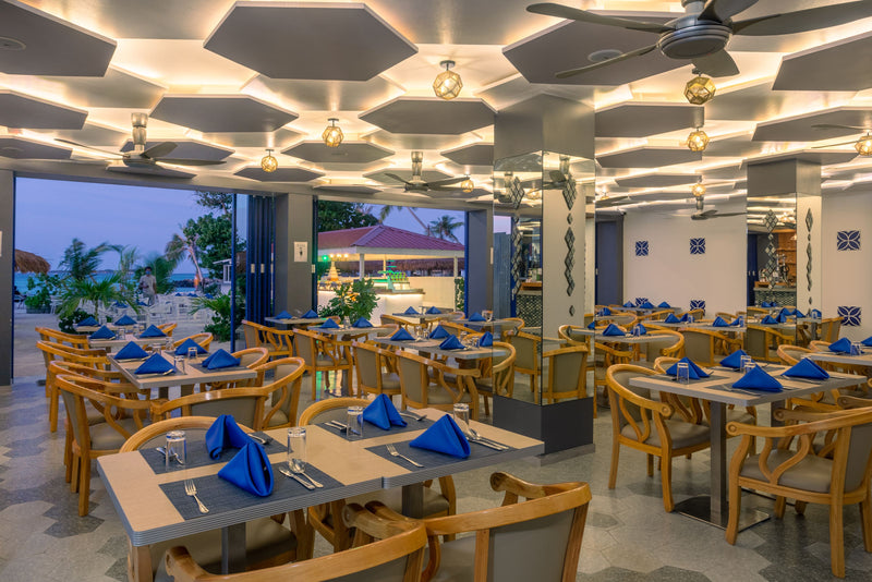 Restaurant at Kaani Palm Beach with blue and white table settings