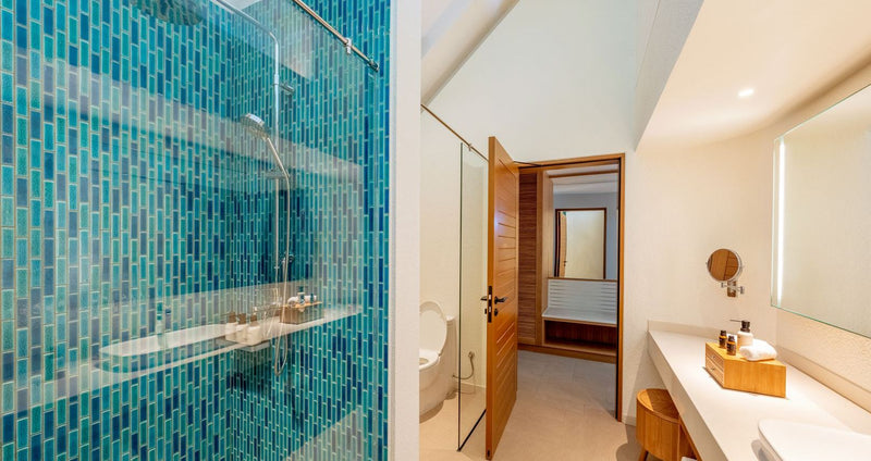 RAAYA by Atmosphere, Raa Atoll: a villa bathroom with a blue-tiled shower