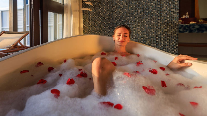 A bath drawn with bubbles and petals in a Wind Villa at OZEN LIFE Maadhoo