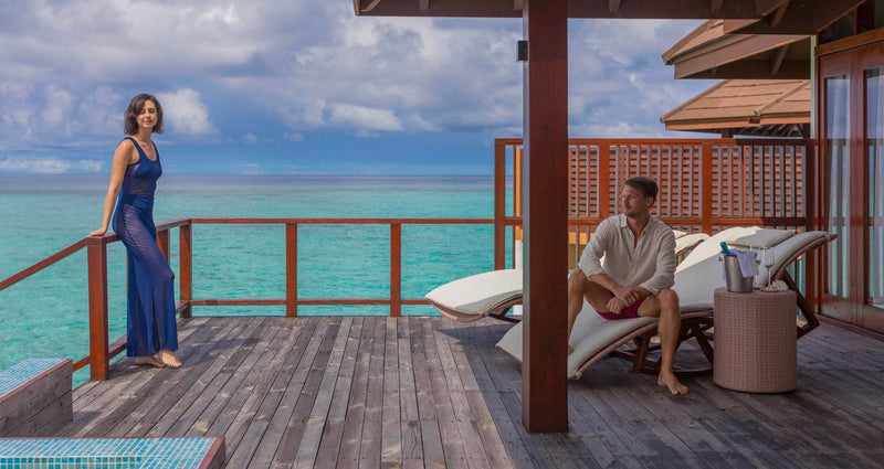 VARU by Atmosphere, North Malé Atoll: a couple on the deck of a water villa
