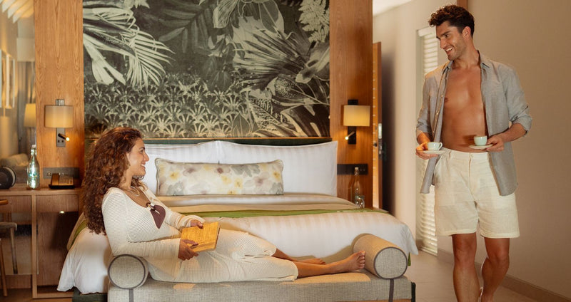 RAAYA by Atmosphere, Raa Atoll: a couple in a beach villa bedroom