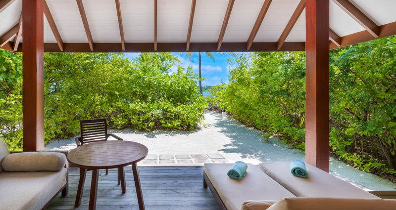 VARU by Atmosphere, North Malé Atoll: a beach villa terrace with loungers and a sand path to the beach