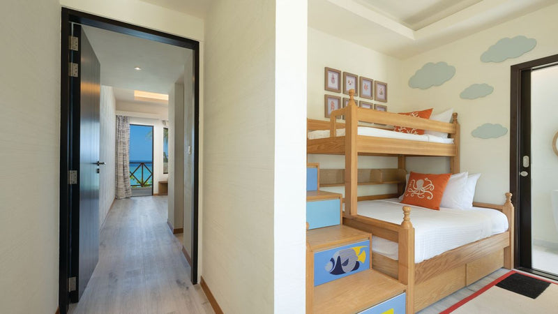 OBLU Xperience Ailafushi, North Malé Atoll: the Ocean View Family Two Bedroom, with the children's bunk room beyond the corridor