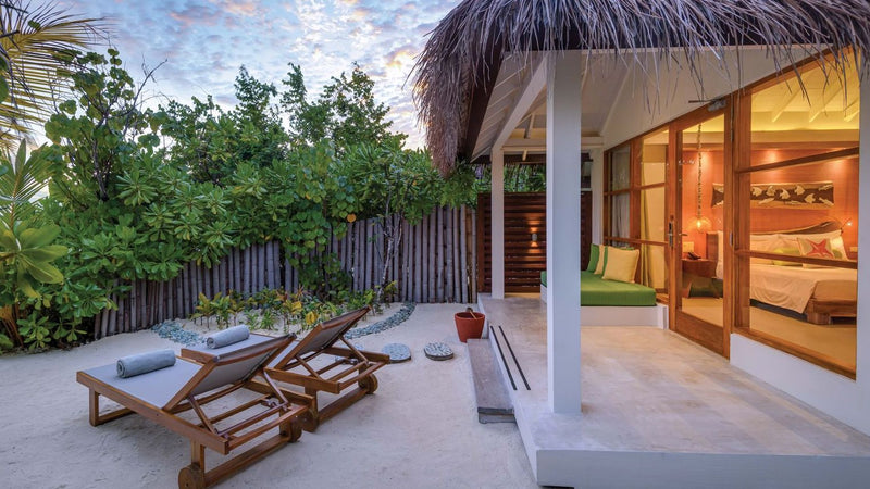 OBLU SELECT Sangeli, North Malé Atoll: the terrace and open doors of a beach villa at dusk