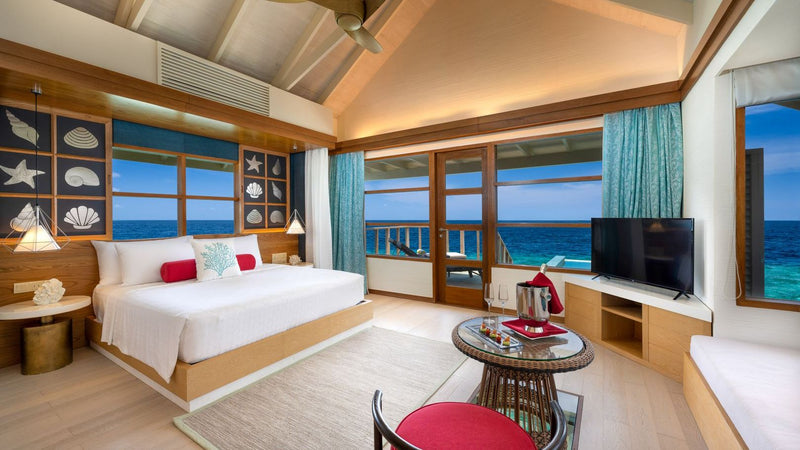 OBLU SELECT Lobigili, North Malé Atoll: a SunNest Water Pool Villa bedroom and sitting area