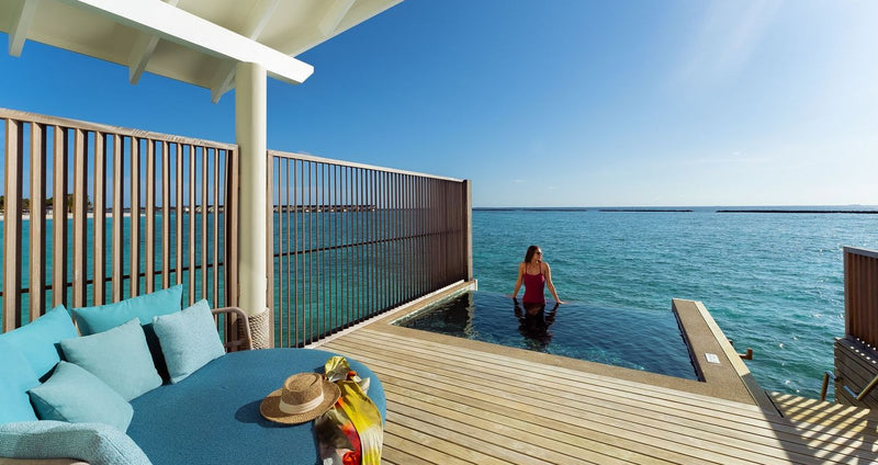 RAAYA by Atmosphere, Raa Atoll: a guest in the plunge pool on a water villa deck