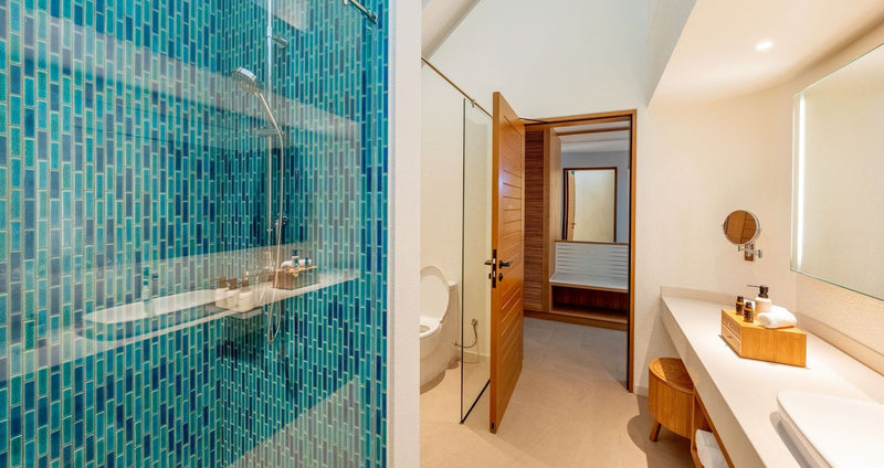 RAAYA by Atmosphere, Raa Atoll: a beach villa bathroom with a blue-tiled shower
