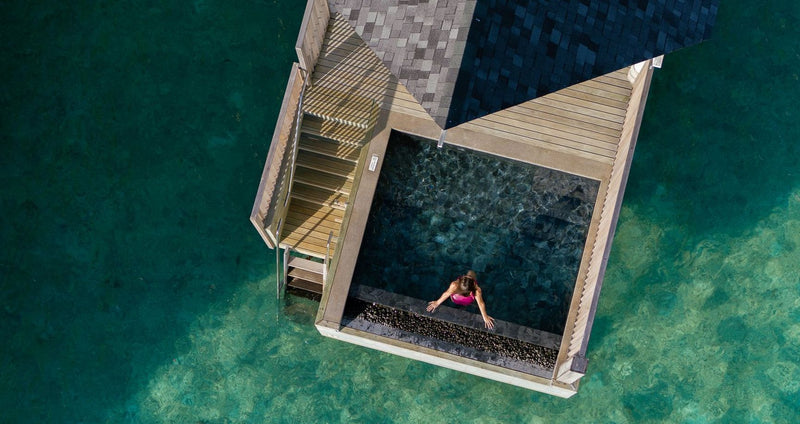 RAAYA by Atmosphere, Raa Atoll: from above, a water villa deck with its steps down to the lagoon