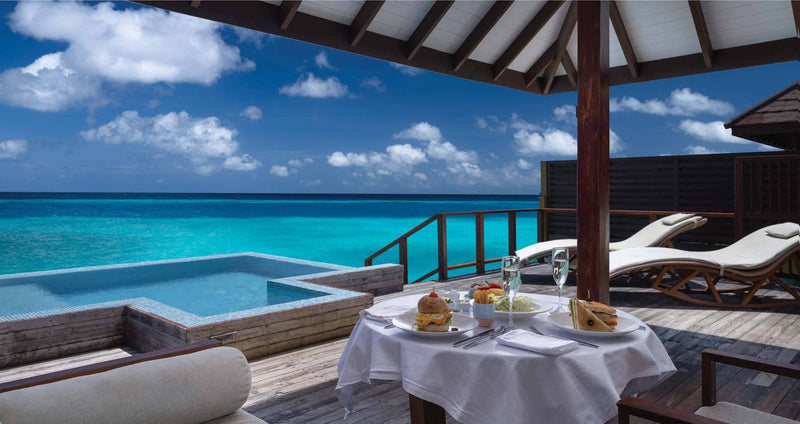 VARU by Atmosphere, North Malé Atoll: breakfast laid beside the pool on a water villa deck
