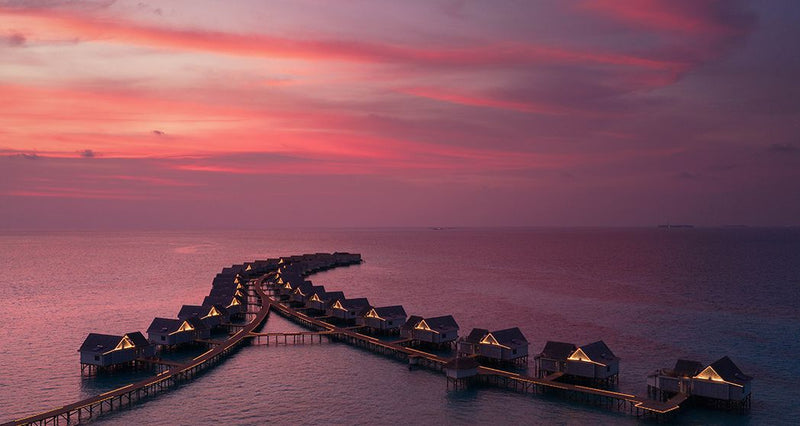 The overwater villas at RAH GILI Maldives at sunset.