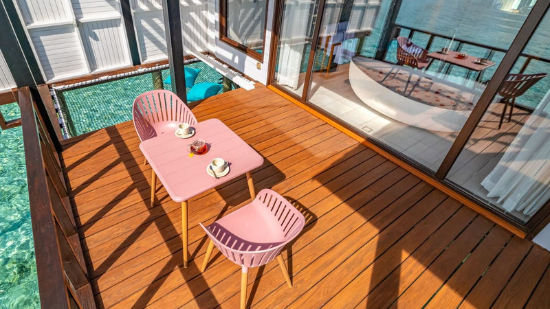 The deck of a Wind Villa with Pool at OZEN LIFE Maadhoo, a pink table and two chairs set beside the plunge pool