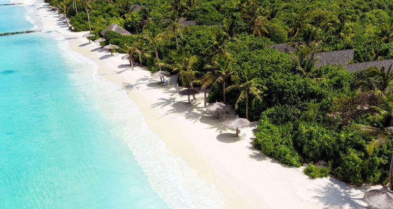 RAAYA by Atmosphere, Raa Atoll: from the air, the white beach with beach villas among the trees