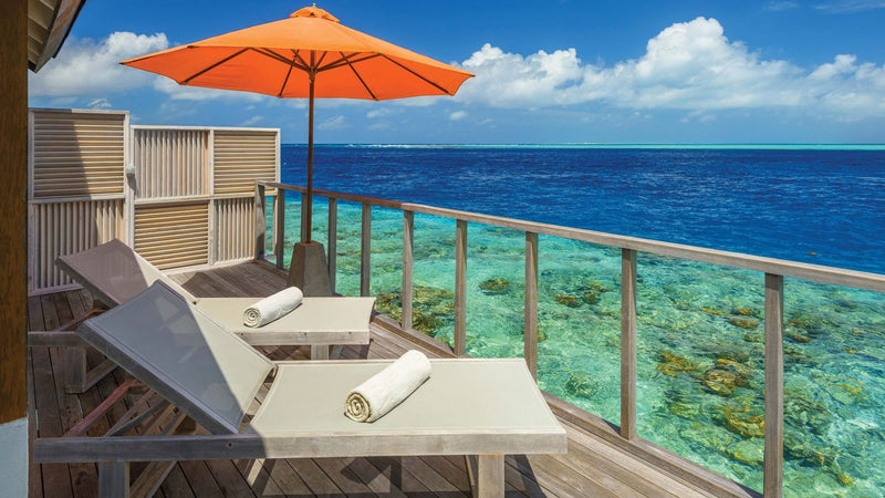 OBLU SELECT Sangeli, North Malé Atoll: the deck of a water villa, loungers and an umbrella over the reef