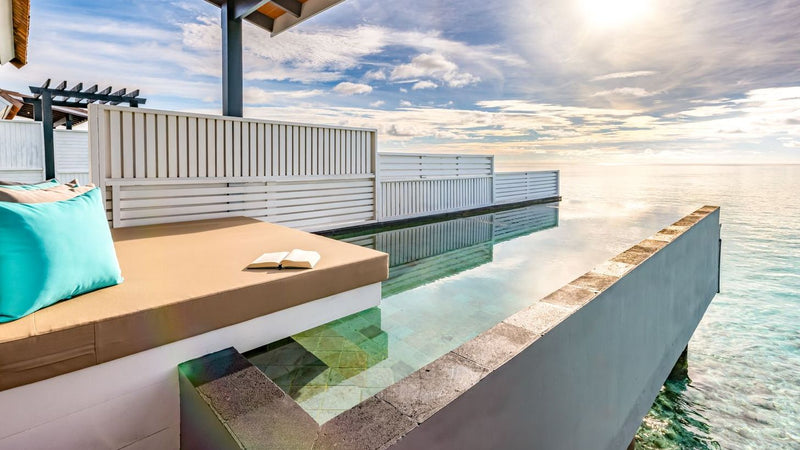 The pool of a Wind Villa with Pool at OZEN LIFE Maadhoo, running to the edge of the deck above the open sea