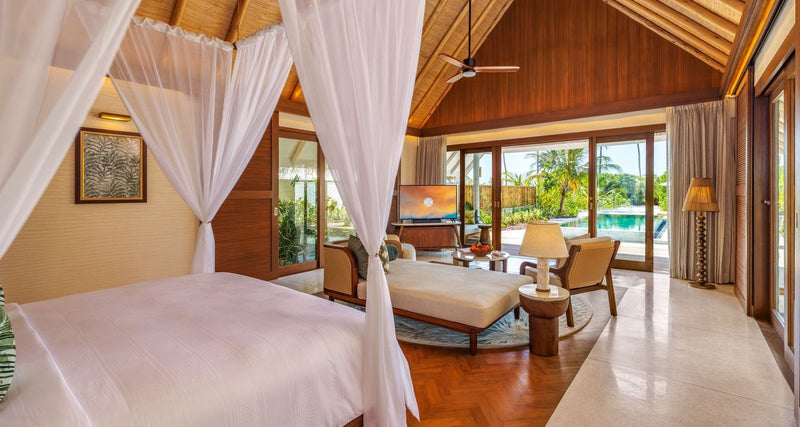 A bedroom with a four-poster bed at RAH GILI Maldives.