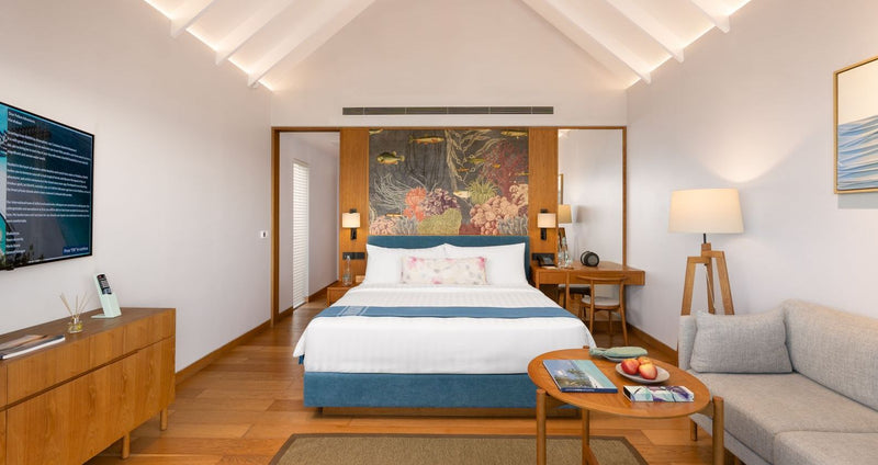 RAAYA by Atmosphere, Raa Atoll: a villa bedroom with a tropical mural behind the bed