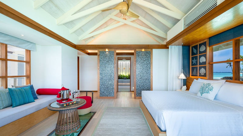 OBLU SELECT Lobigili, North Malé Atoll: a Nest Water Villa bedroom and sitting area